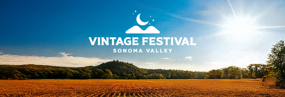 Grapes in fall wih mountains and he Vintage Festival logo